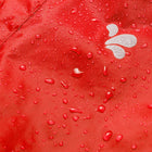 Close-up of the red Originals Waterproof Trousers with water droplets, showcasing the waterproof material and small white logo.